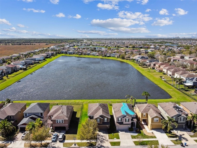 birds eye view of property with a water view and a residential view