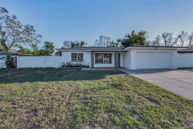 ranch-style home with an attached garage, a front yard, fence, and stucco siding