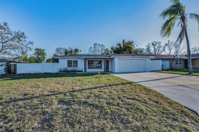 view of front of property with a garage, fence, driveway, stucco siding, and a front lawn