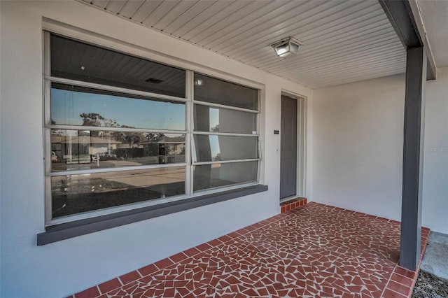 property entrance featuring brick siding