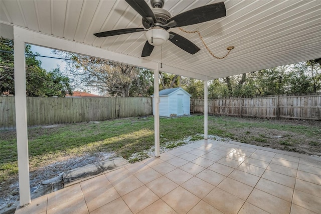 view of patio featuring ceiling fan, a shed, a fenced backyard, and an outdoor structure