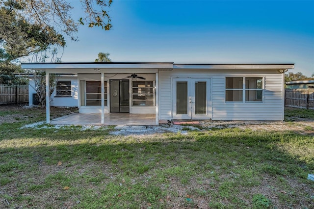 back of property featuring a yard, a patio area, fence, and a ceiling fan