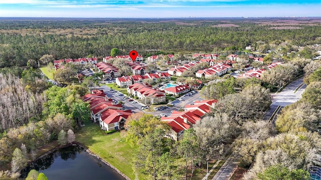 birds eye view of property featuring a wooded view