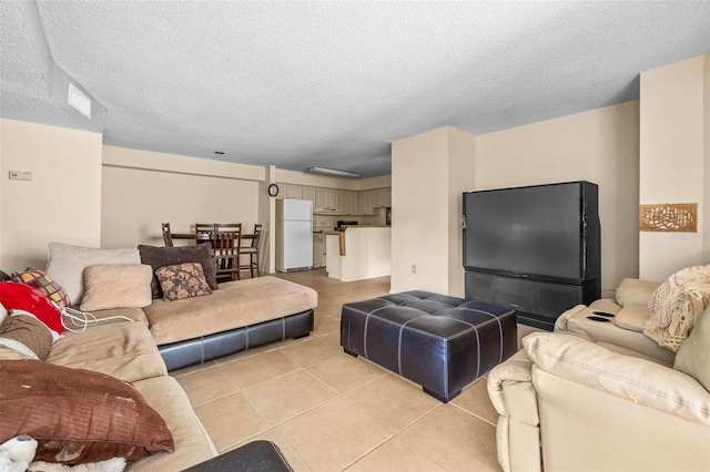 living room featuring light tile patterned floors and a textured ceiling