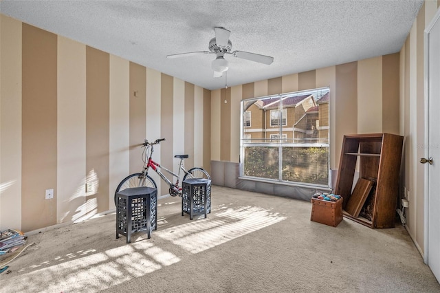 game room featuring carpet flooring, ceiling fan, a textured ceiling, and wallpapered walls