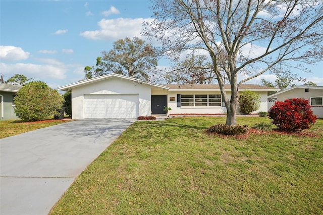 ranch-style home featuring a front lawn, an attached garage, concrete driveway, and stucco siding