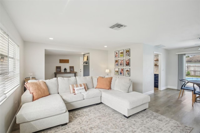 living room featuring visible vents, recessed lighting, baseboards, and wood finished floors