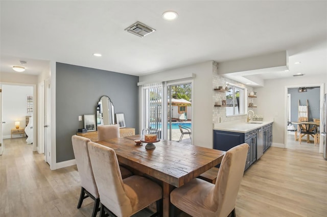 dining space featuring light wood-type flooring, visible vents, baseboards, and recessed lighting