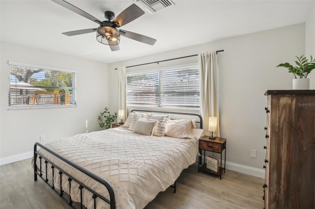 bedroom with light wood-type flooring, visible vents, and multiple windows