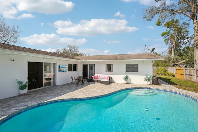 rear view of house with fence, a patio area, a fenced in pool, and stucco siding