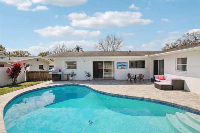 back of property featuring a fenced in pool, a patio, stucco siding, and fence