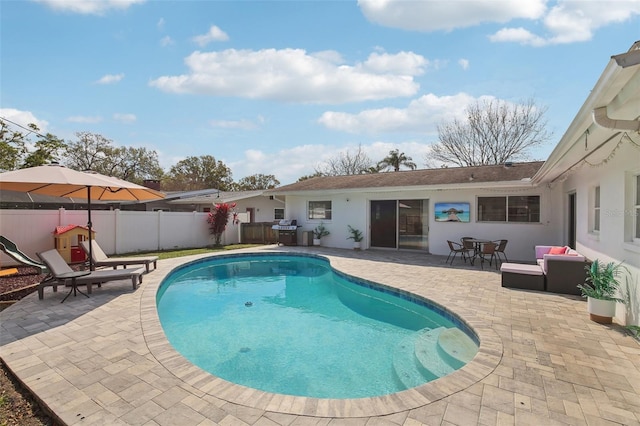 view of swimming pool with a patio area, a fenced in pool, a fenced backyard, and a grill