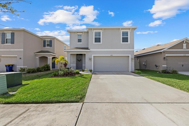 traditional home with an attached garage, concrete driveway, a front yard, and stucco siding