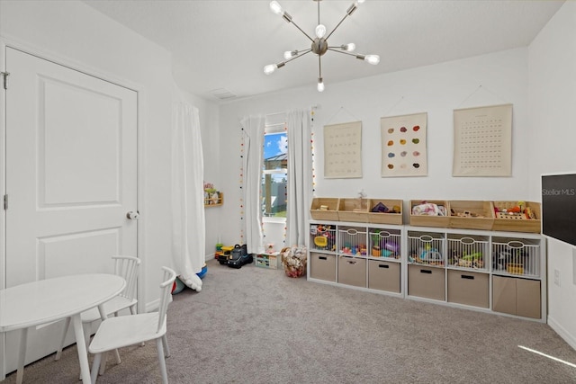 recreation room featuring carpet floors and an inviting chandelier