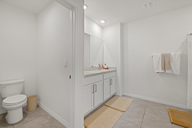 full bath featuring toilet, vanity, visible vents, and tile patterned floors