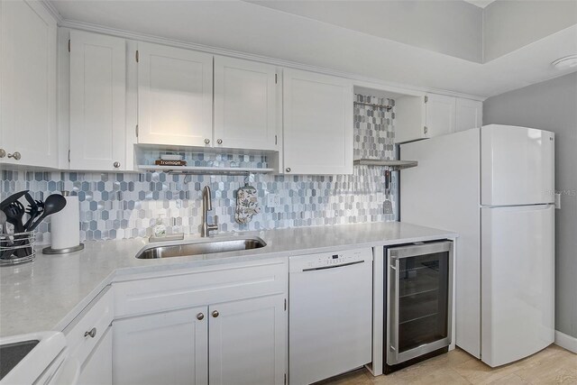 kitchen with white appliances, beverage cooler, open shelves, and a sink