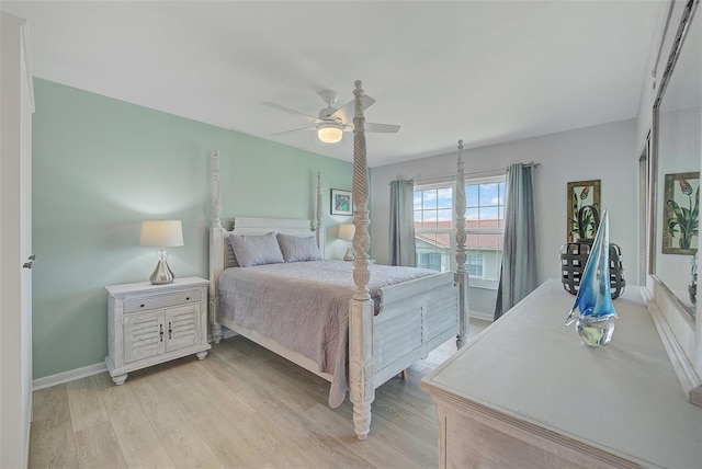 bedroom featuring light wood-type flooring, baseboards, and ceiling fan