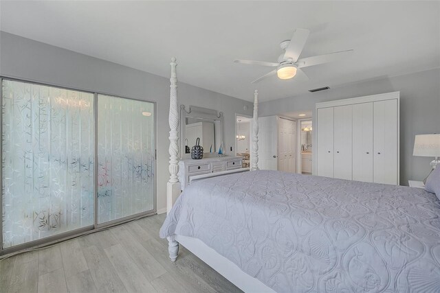 unfurnished bedroom with visible vents, two closets, light wood-style flooring, and a ceiling fan