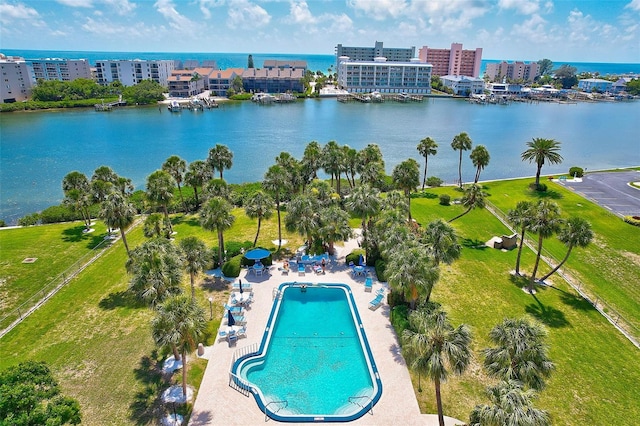 drone / aerial view featuring a city view and a water view