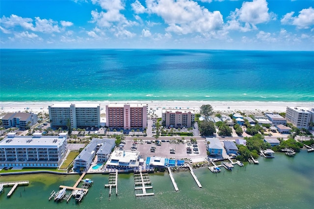 birds eye view of property with a beach view, a view of city, and a water view