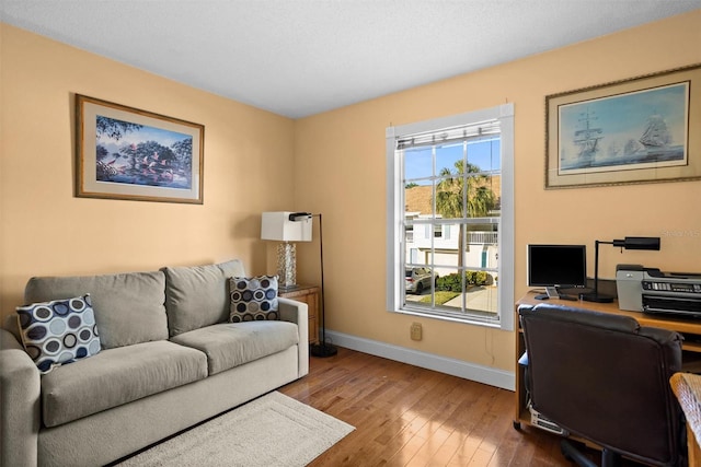 office space with hardwood / wood-style flooring and baseboards