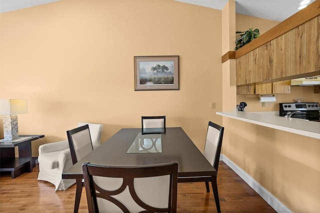 dining area with wood finished floors and baseboards