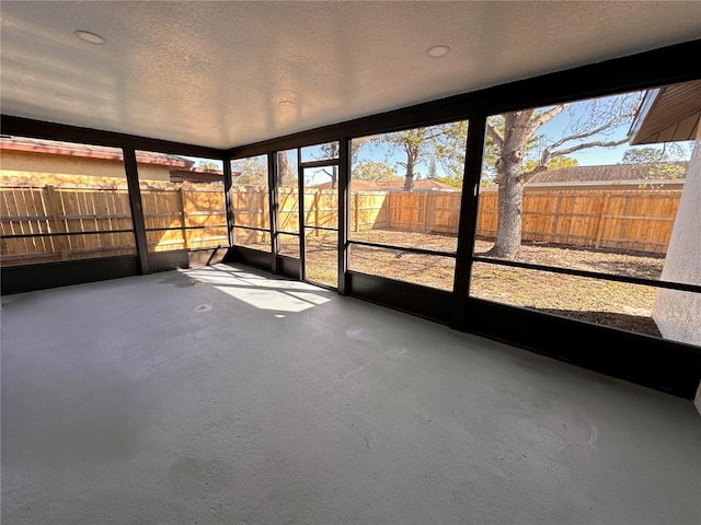 unfurnished sunroom with a wealth of natural light