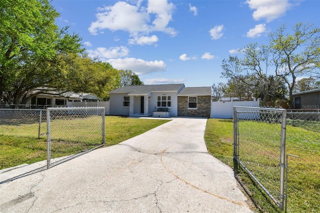 view of front of home featuring concrete driveway, a fenced front yard, and a front yard