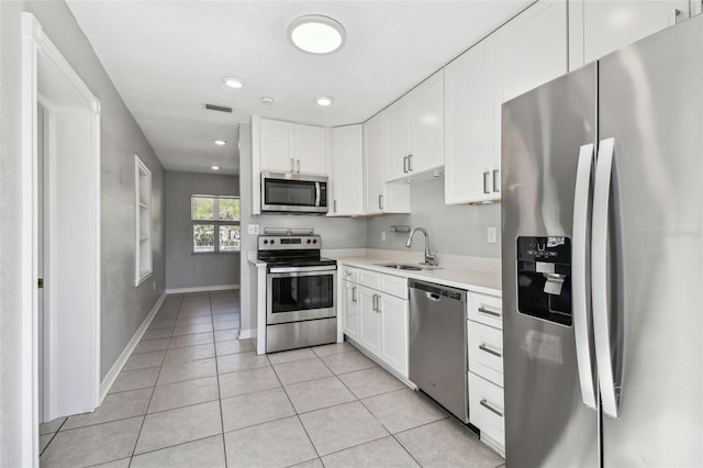 kitchen featuring visible vents, white cabinets, appliances with stainless steel finishes, light countertops, and a sink