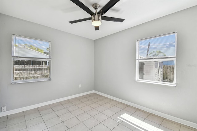 unfurnished room with plenty of natural light and baseboards