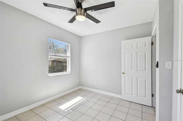 unfurnished room with light tile patterned floors, ceiling fan, and baseboards