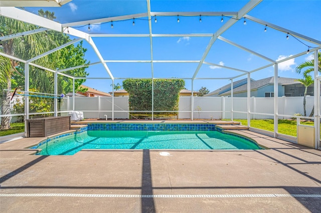 view of swimming pool with glass enclosure, a patio area, a fenced backyard, and a fenced in pool