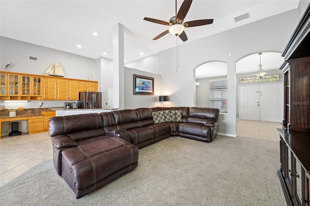 living area featuring visible vents, light colored carpet, high vaulted ceiling, built in desk, and recessed lighting