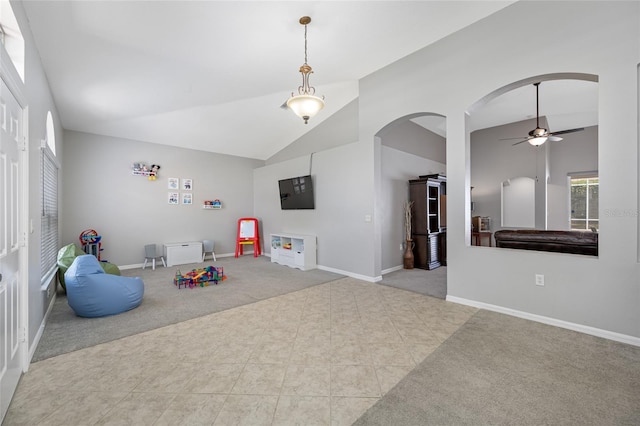 rec room featuring arched walkways, carpet flooring, ceiling fan, and baseboards