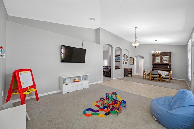 game room featuring arched walkways, a chandelier, lofted ceiling, baseboards, and carpet