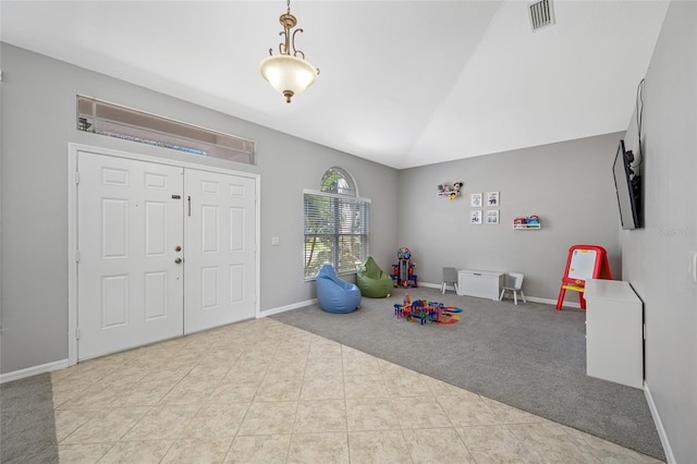 rec room with carpet floors, visible vents, baseboards, vaulted ceiling, and tile patterned floors