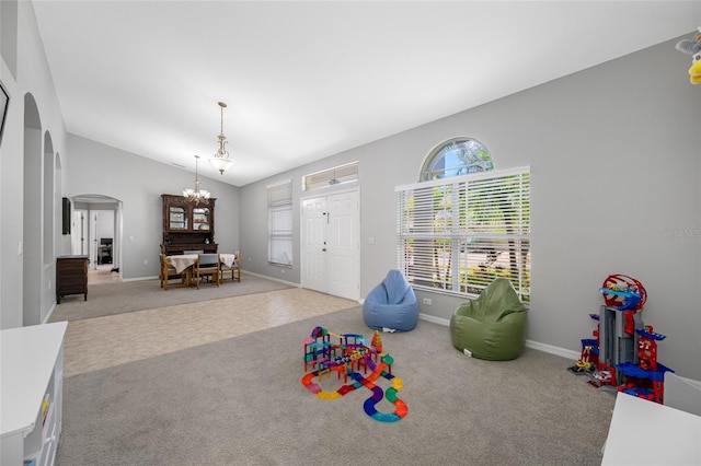 rec room featuring arched walkways, a chandelier, lofted ceiling, carpet flooring, and baseboards