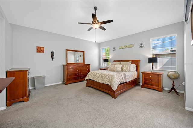 bedroom with carpet floors, multiple windows, and baseboards