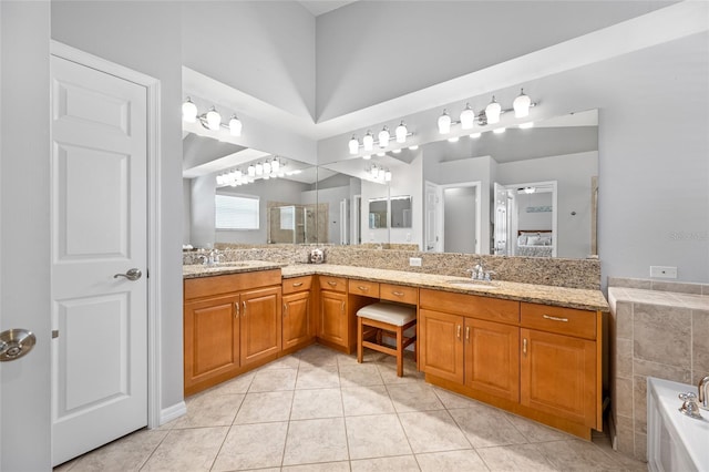 full bath with a garden tub, a sink, tile patterned floors, double vanity, and a shower with door