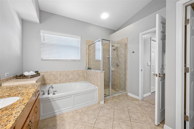 full bathroom featuring vanity, a shower stall, a bath, and tile patterned floors