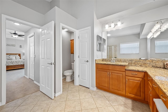 ensuite bathroom with a stall shower, toilet, ensuite bath, tile patterned floors, and vanity