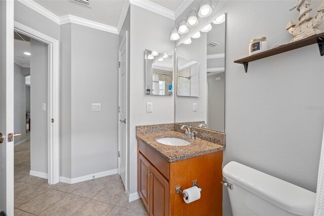 bathroom featuring baseboards, toilet, ornamental molding, tile patterned floors, and vanity