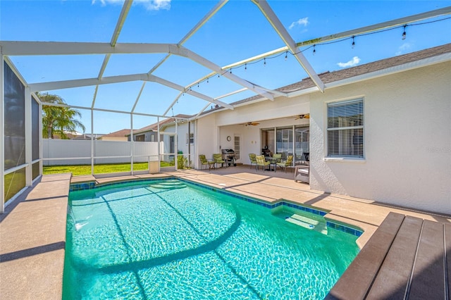 view of pool featuring a fenced in pool, a ceiling fan, glass enclosure, a patio area, and fence