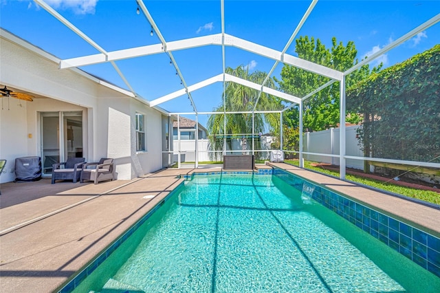 view of pool with a patio, a fenced backyard, and a lanai