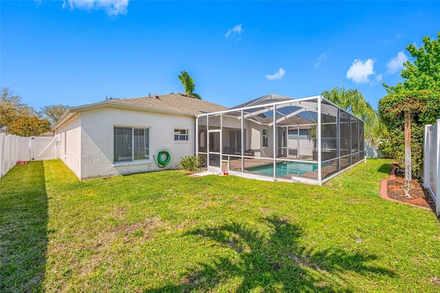 rear view of house with a fenced backyard, a lanai, a lawn, a fenced in pool, and a gate