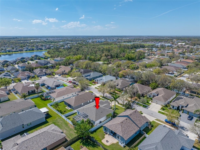 drone / aerial view featuring a water view and a residential view