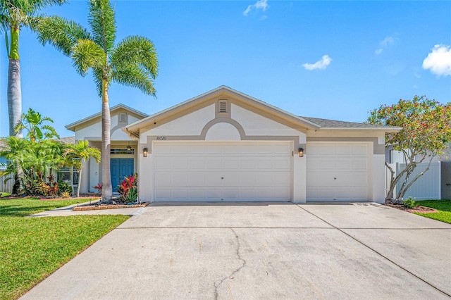 ranch-style home with an attached garage, a front yard, concrete driveway, and stucco siding