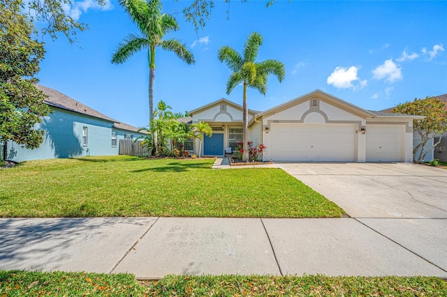 view of front facade with an attached garage, fence, concrete driveway, stucco siding, and a front yard