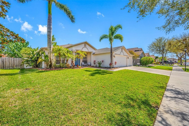 view of front facade featuring a garage, fence, concrete driveway, and a front yard