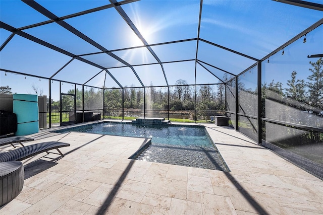 pool featuring glass enclosure and a patio area